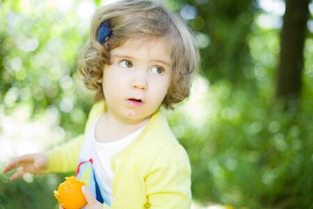 young girl portrait at the gardenの写真素材