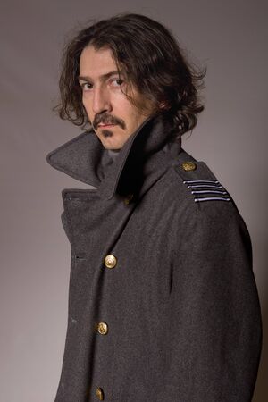 young man dressed as russian military, studio picture