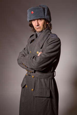 young man dressed as russian military, studio picture