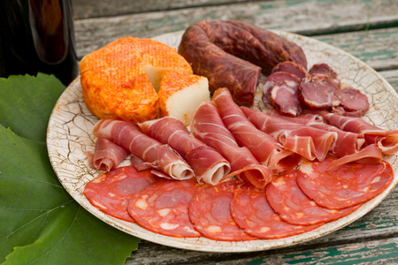 Country life setting with wine, fruits, cheese and meat. Outdoorの写真素材