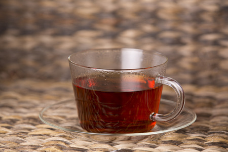hot tea in glass cup on a wooden tableの写真素材
