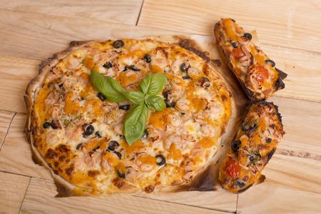 home made hot pizza on wooden tableの写真素材