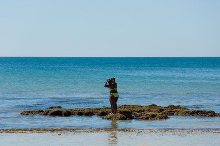 People at the famous beach of Olhos de Agua in Albufeira. This beach is a part of famous tourist region of Algarve.のeditorial素材
