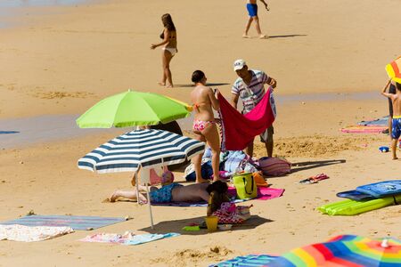 ALBUFEIRA, PORTUGAL - AUGUST 21, 2016: People at the famous beach of Olhos de Agua in Albufeira. This beach is a part of famous tourist region of Algarve.のeditorial素材