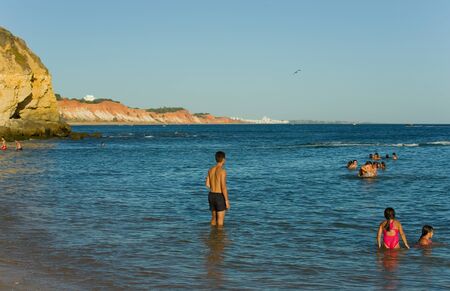 ALBUFEIRA, PORTUGAL - AUGUST 20, 2016: People at the famous beach of Olhos de Agua in Albufeira. This beach is a part of famous tourist region of Algarve.のeditorial素材