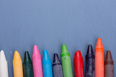 Wax crayons on a blue wooden backgroundの写真素材