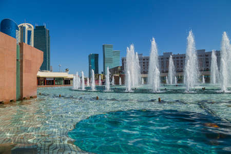 Nur-Sultan, Kazakhstan - April 24, 2019 - New business district with traffic on road and park with...