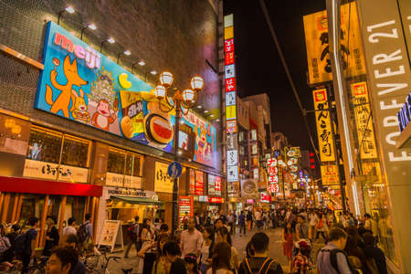 Osaka, Japan: Tourist walking in a shopping street called Dotonbori Street. Giant moving crab on restaurant in Dotonbori Osaka, Namba Dotonbori area at night, Osaka, Japanのeditorial素材