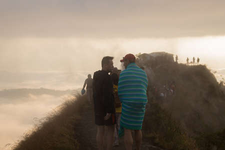 BALI, INDONESIA: Group of people watch the dawn on top of the Batur volcano in Bali, Indonesia.のeditorial素材