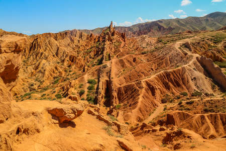 Red sandstone rock formations Seven bulls and Broken heart, Jeti Oguz canyon in Kyrgyzstan, Issyk-Kul region, Central Asiaの写真素材