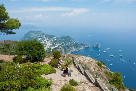 CAPRI, ITALY: Tourists at the top of the mountain. View of Faraglioni cliffs and Tyrrhenian Sea on Capri Island, Italyのeditorial素材