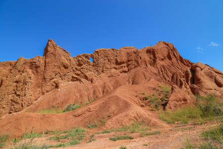 Red sandstone rock formations Seven bulls and Broken heart, Jeti Oguz canyon in Kyrgyzstan, Issyk-Kul region, Central Asiaの写真素材