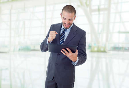 happy businessman working with a tablet pc, at the officeの写真素材