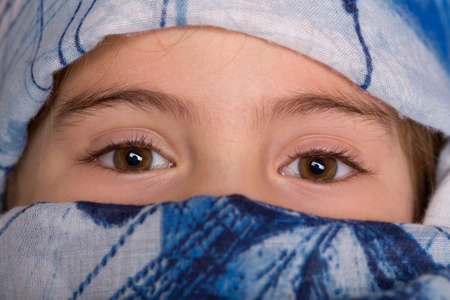 young girl with a veil covering her, close up, studio pictureの写真素材