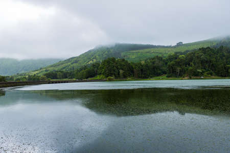 View of the Lake of Sete Cidades in the fog, a volcanic crater lake on Sao Miguel island, Azores, Portugalの写真素材