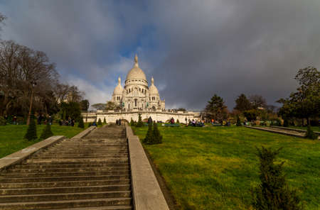 PARIS, FRANCE: Sacre-Coeur church, Paris citiscape view over the roofs with dramatic winter sky. Franceのeditorial素材