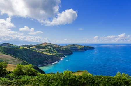 View from the Miradouro de Santa Iria on the island of SÃ£o Miguel in the Azores. The view shows part of the northern coastline with cliffs and green fields on the clifftop.の写真素材