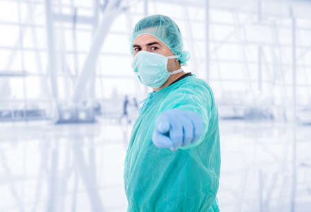 male doctor pointing at the hospitalの写真素材