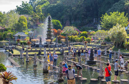 Bali, Indonesia: People walking on the stepstones of Tirtagangga Water Palace in Bali, Indonesiaのeditorial素材