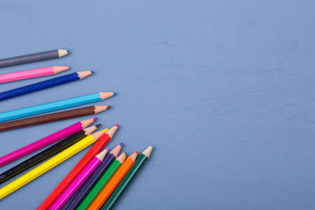 Used color pencils over a blue wooden background