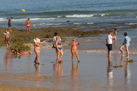 ALBUFEIRA, PORTUGAL: People at the famous beach of Olhos de Agua in Albufeira. This beach is a part of famous tourist region of Algarve.のeditorial素材