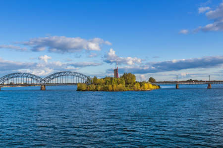 A view of the Railway Bridge over Daugava River in Riga, Latviaの写真素材