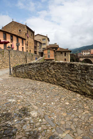 Potes, Spain - June 1, 2018: The river and traditional houses in the ancient Spanish town. Northern Spain, Cantabria.のeditorial素材