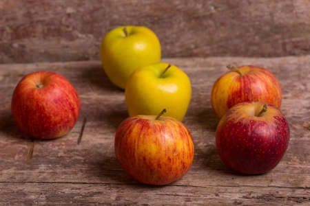 red apples on a old wooden table, studio pictureの写真素材