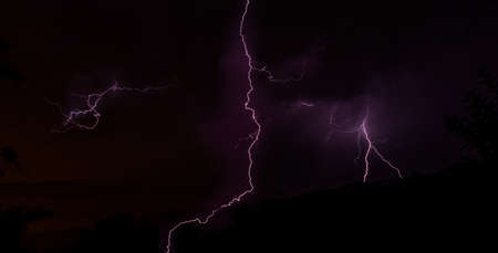 Lightning bolts during an evening thunderstorm over Geres National Park, Amares, Portugalの写真素材