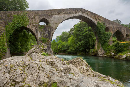 the Roman bridge built in the late 13th century over the Sella River in Cangas de Onis, Asturias, Spain.の写真素材