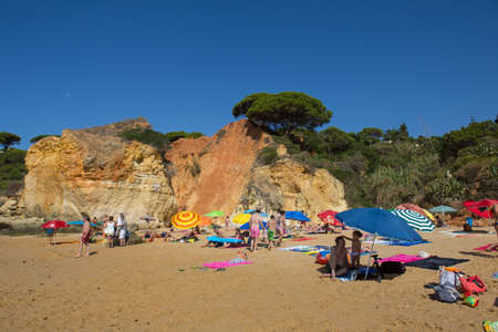 ALBUFEIRA, PORTUGAL: People at the famous beach of Olhos de Agua in Albufeira. This beach is a part of famous tourist region of Algarve.のeditorial素材