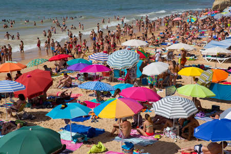 ALBUFEIRA, PORTUGAL: People at the famous beach of Olhos de Agua in Albufeira. This beach is a part of famous tourist region of Algarve.のeditorial素材