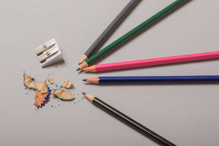 Wooden colorful pencils with sharpening shavings, on wooden tableの写真素材
