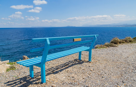 A bench at the coast in the island of Crete, Greeceの写真素材