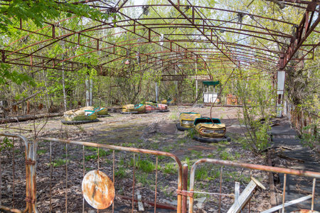 Old broken rusty metal radioactive children's electric cars  abandoned, the park of culture and recreation in the city of Pripyat, the Chernobyl disaster, Ukraine.の写真素材