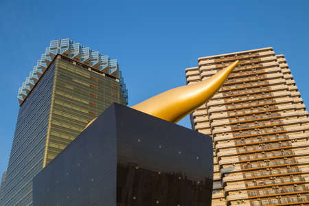 Tokyo. Japan: Asahi Beer buildings. Sunny day. Blue sky. Asahi Breweries headquarters building with the Asahi Flameのeditorial素材