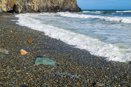 Sunny Day on a Rocky Rugged Beach looking out at ocean in the Copper Coast, Ireland