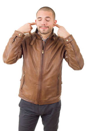 handsome young man covering his ears, isolated white backgroundの写真素材