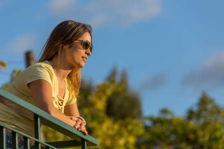 beautiful casual woman enjoying the sunset, outdoorの写真素材