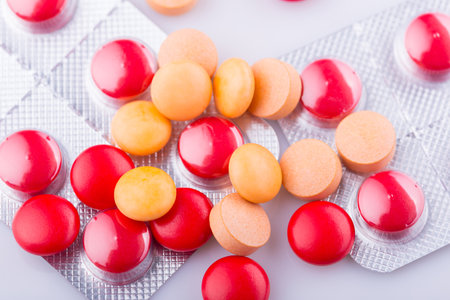 Tablets pills capsule heap mix therapy drugs, over a white backgroundの写真素材