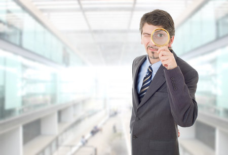 business man with magnifying glass at the officeの写真素材