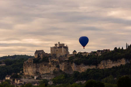 Beynac et Cazenac, Dordogne, France: Hot air balloon flying over Dordogne in southwestern Franceの写真素材
