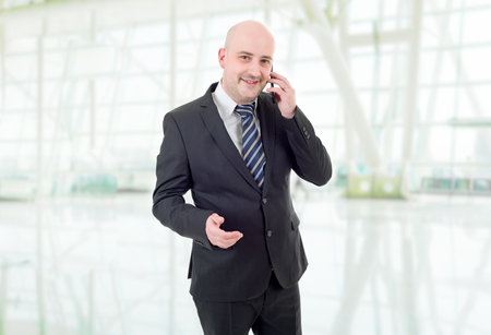 happy business man on the phone, at the officeの写真素材