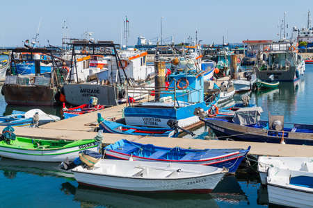 View of the small fishing port of Setubal with its typical blue boats on a summer day. Setubal, Portugalのeditorial素材