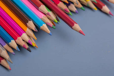 Wooden colorful pencils, on a blue wooden backgroundの写真素材