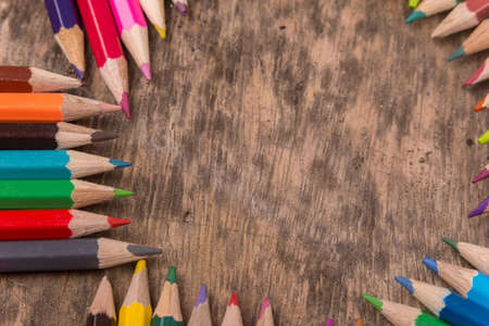 Wooden colorful pencils on a old wooden backgroundの写真素材