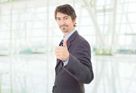 young business man going thumb up, at the officeの写真素材