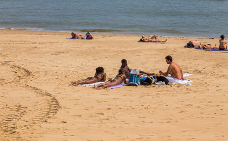 CASCAIS, PORTUGAL: People sunbathing on the Praia da Rainha beach in Cascais, Portugal. Cascais is famous and popular summer vacation spot for Portuguese and foreign touristsのeditorial素材