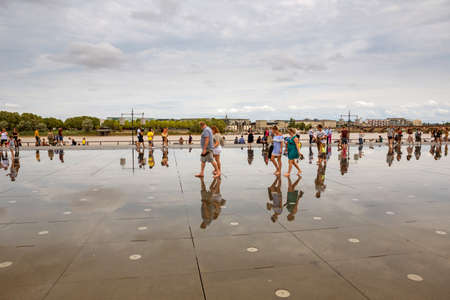 BORDEAUX, FRANCE: The Famous Bordeaux water mirror full of people having fun in the water, in Bordeaux, France.のeditorial素材