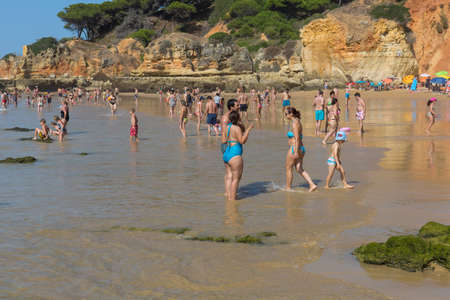 ALBUFEIRA, PORTUGAL: People at the famous beach of Olhos de Agua in Albufeira. This beach is a part of famous tourist region of Algarve.のeditorial素材